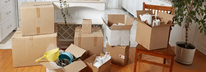 Packed moving boxes and household items in a kitchen before move-out or move-in cleaning, Des Moines, IA.